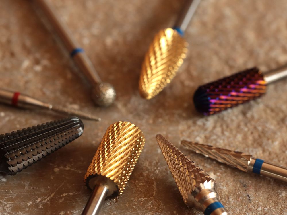 Nail drill machine with various drill bits for manicure and nail care